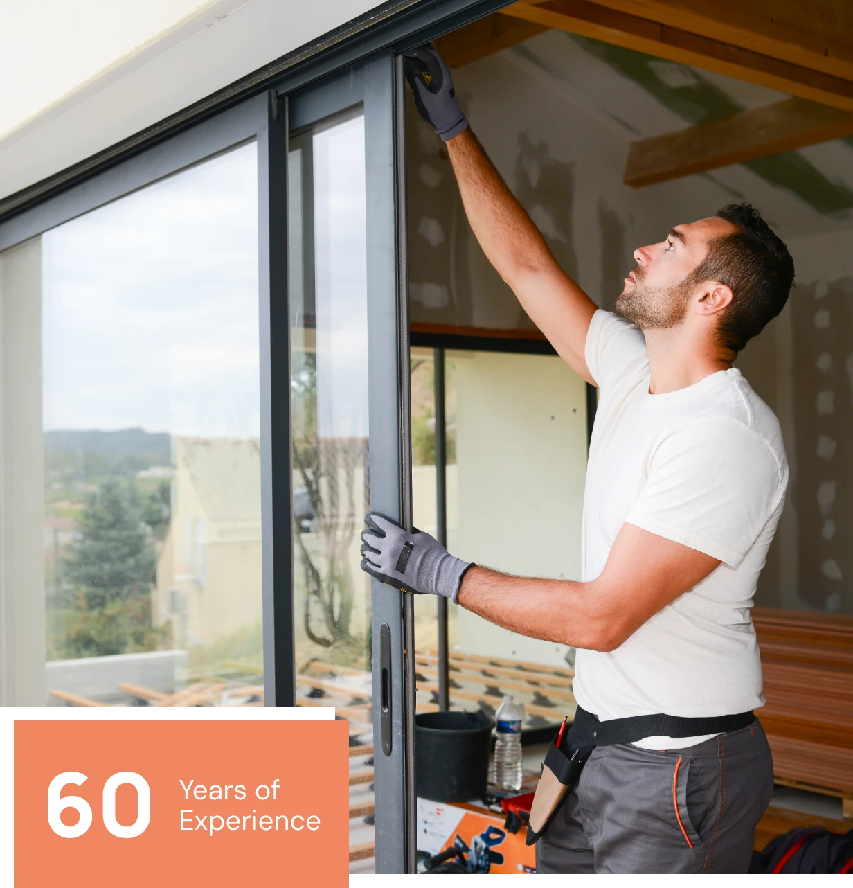 Worker adjusting glass door frame